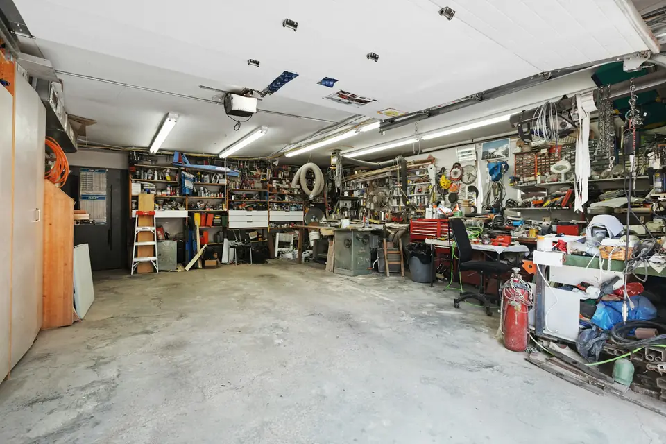 Garage filled with tools, boxes and household clutter