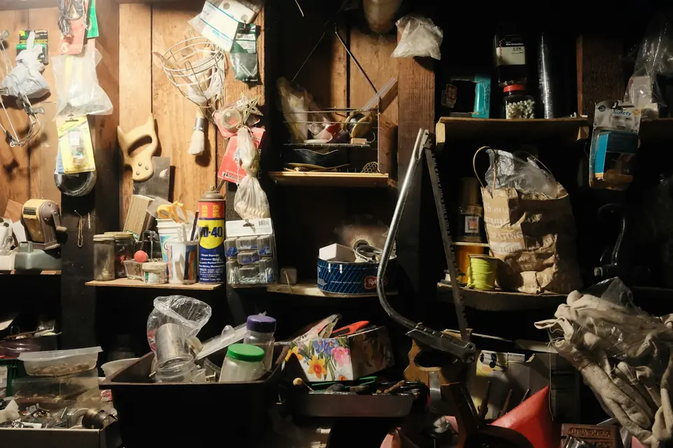 Cluttered storage room with shelves of household items